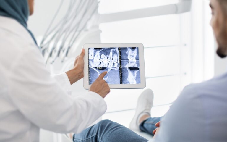 a doctor looking at x-ray of a patient at klinik gigi kota bharu, amal medik